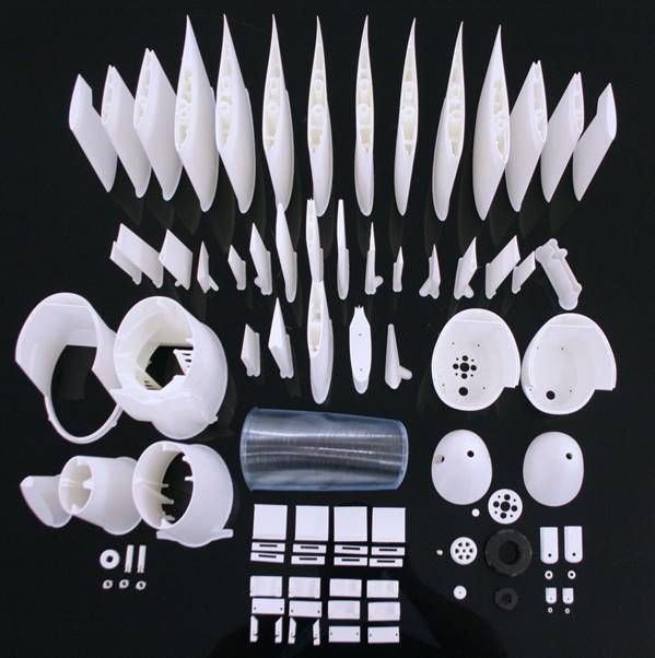 A group of white plastic parts Description automatically generated