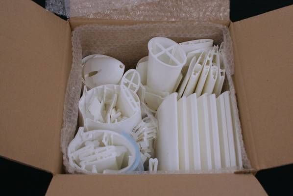 A box full of white plastic Description automatically generated